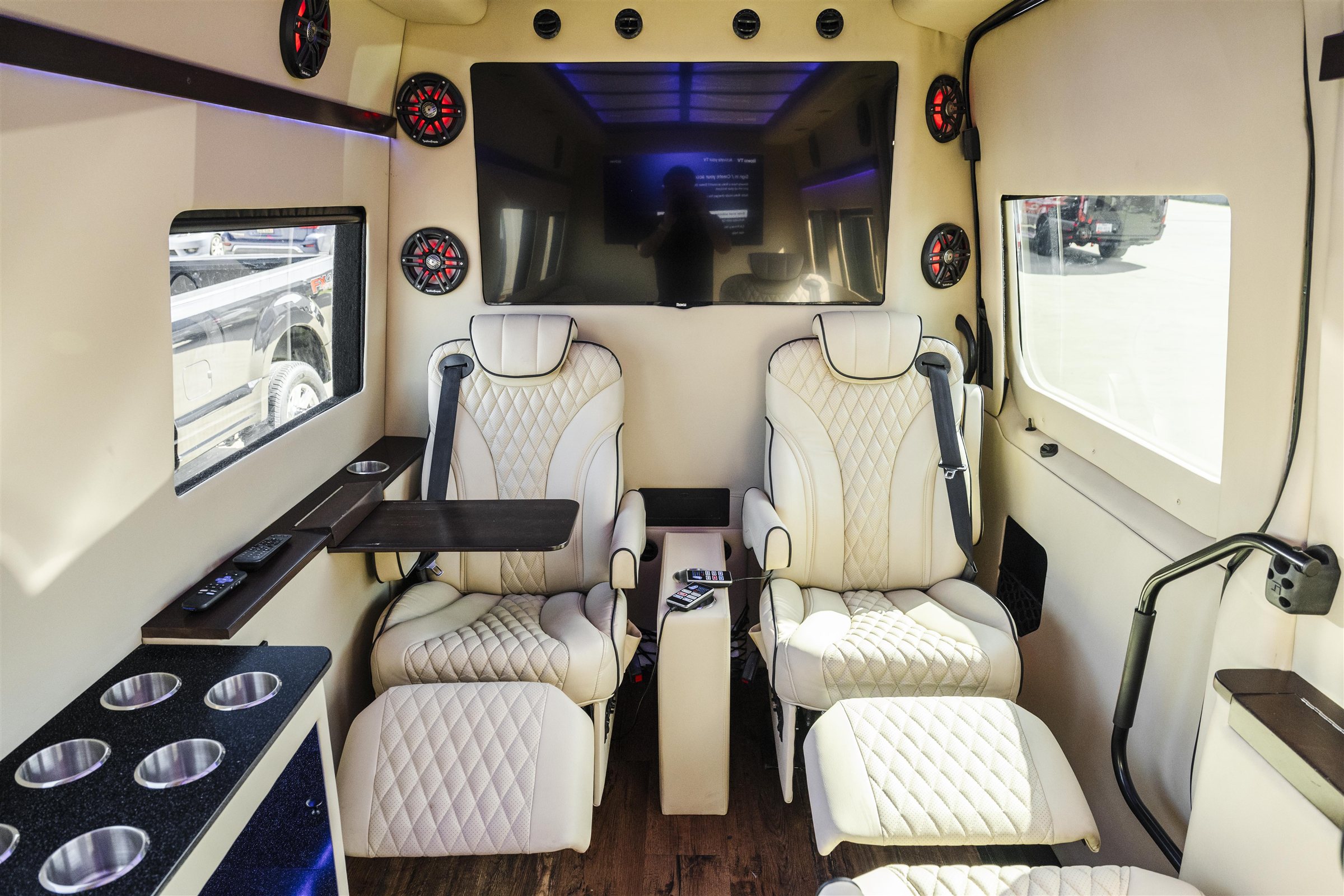 Cream captain seats in a luxury Sprinter van