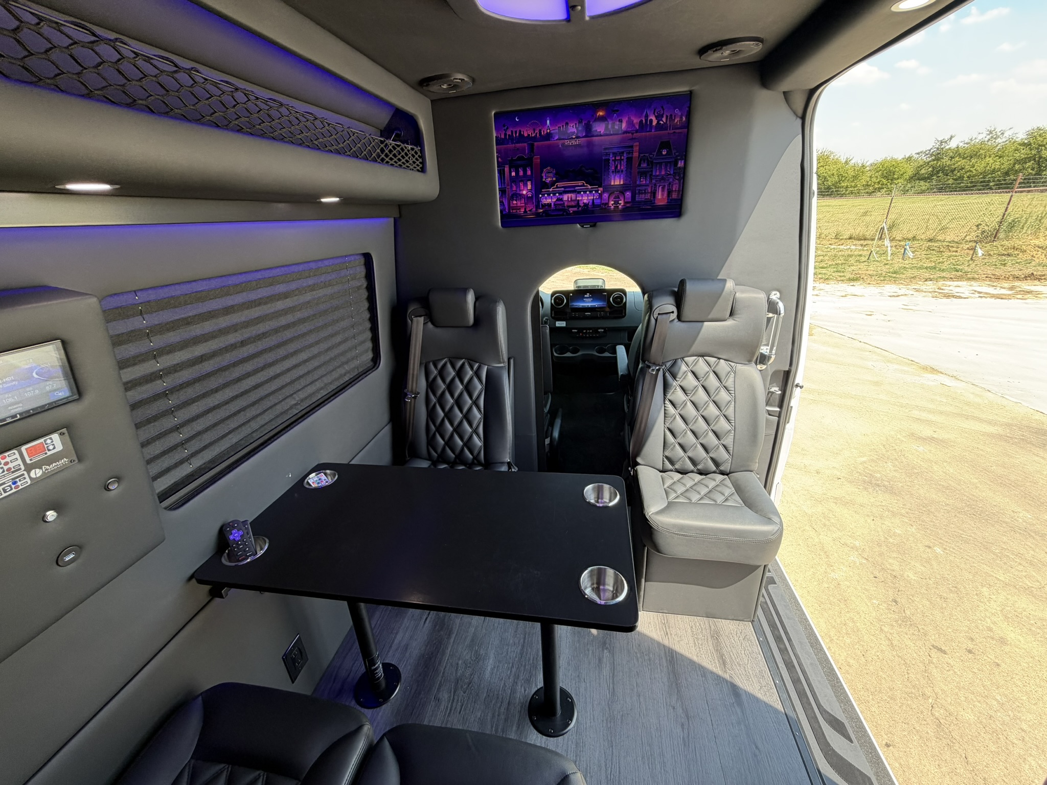 Executive Lounge Shuttle with a passenger table and gray seating